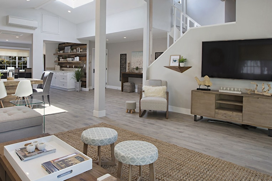 Bright, spacious living room with modern decor, a large TV, and cozy seating, in a luxurious 7-bedroom villa in La Jolla Village.